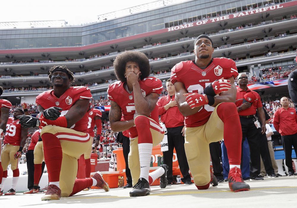 In this Oct. 2, 2016, file photo, from left, San Francisco 49ers Eli Harold, Colin Kaepernick, center, and Eric Reid kneel during the national anthem before an NFL football game against the Dallas Cowboys in Santa Clara, Calif. (Marcio Jose Sanchez/AP)