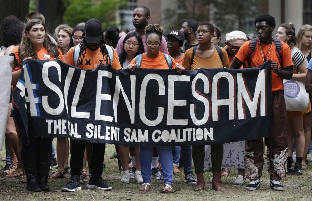 Protesters gather at a Confederate monument known as &quot;Silent Sam&quot; on campus at the University of North Carolina in Chapel Hill, N.C., Thursday, Aug. 31, 2017. Students staging an around-the-clock protest against the statue were joined by hundreds of supporters Thursday after police took away picnic tables and other equipment used for the sit-in. (Gerry Broome/AP)