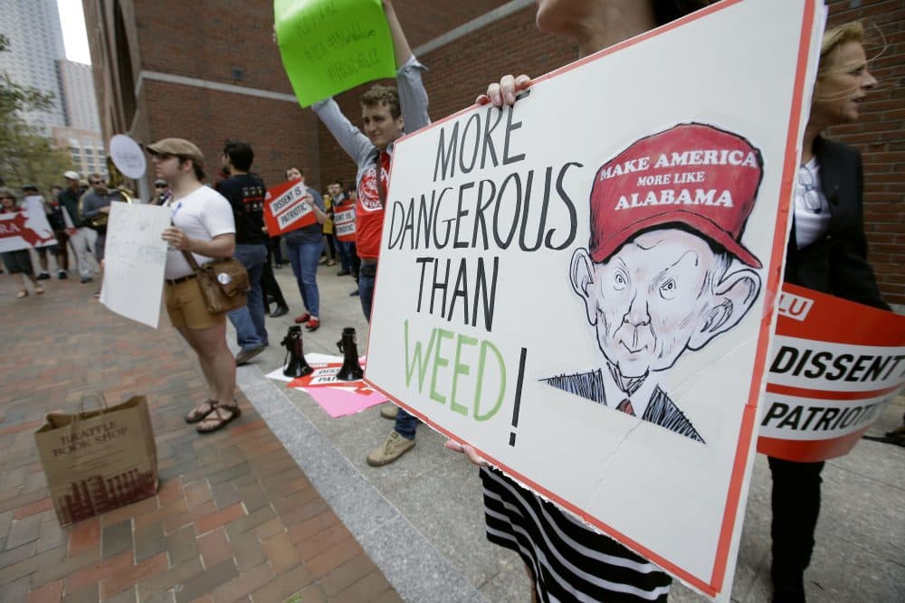 Jean Inglis, of Nahant, Mass., holds a sign depicting Attorney General Jeff Sessions as she protests Thursday with others outside the federal courthouse in Boston where Sessions was speaking to law enforcement officials about international organized crime. (Steven Senne/AP)