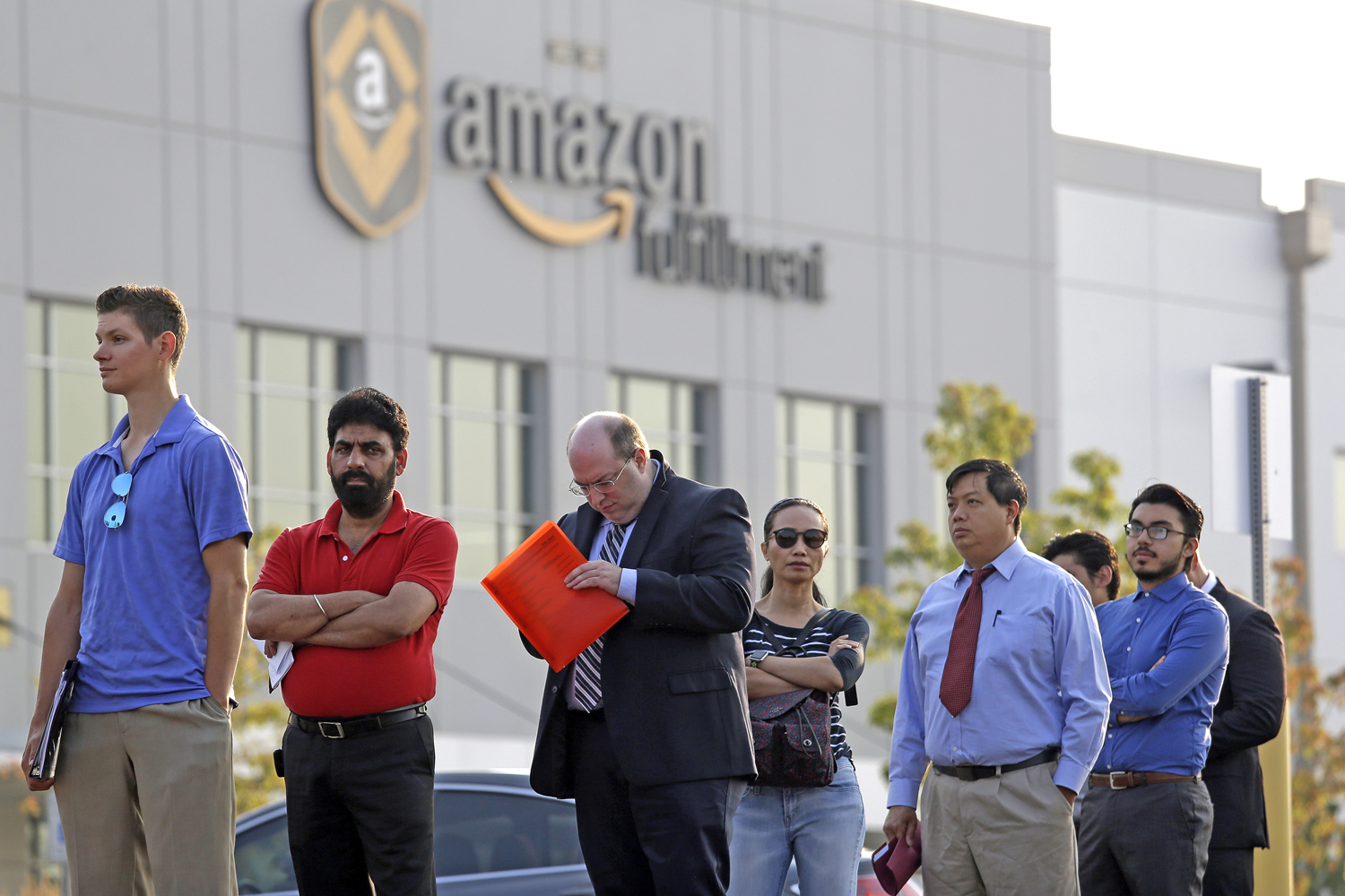 Applicants wait in line to enter a job fair, Wednesday, Aug. 2, 2017, at an Amazon fulfillment center, in Kent, Wash. (Elaine Thompson/AP)