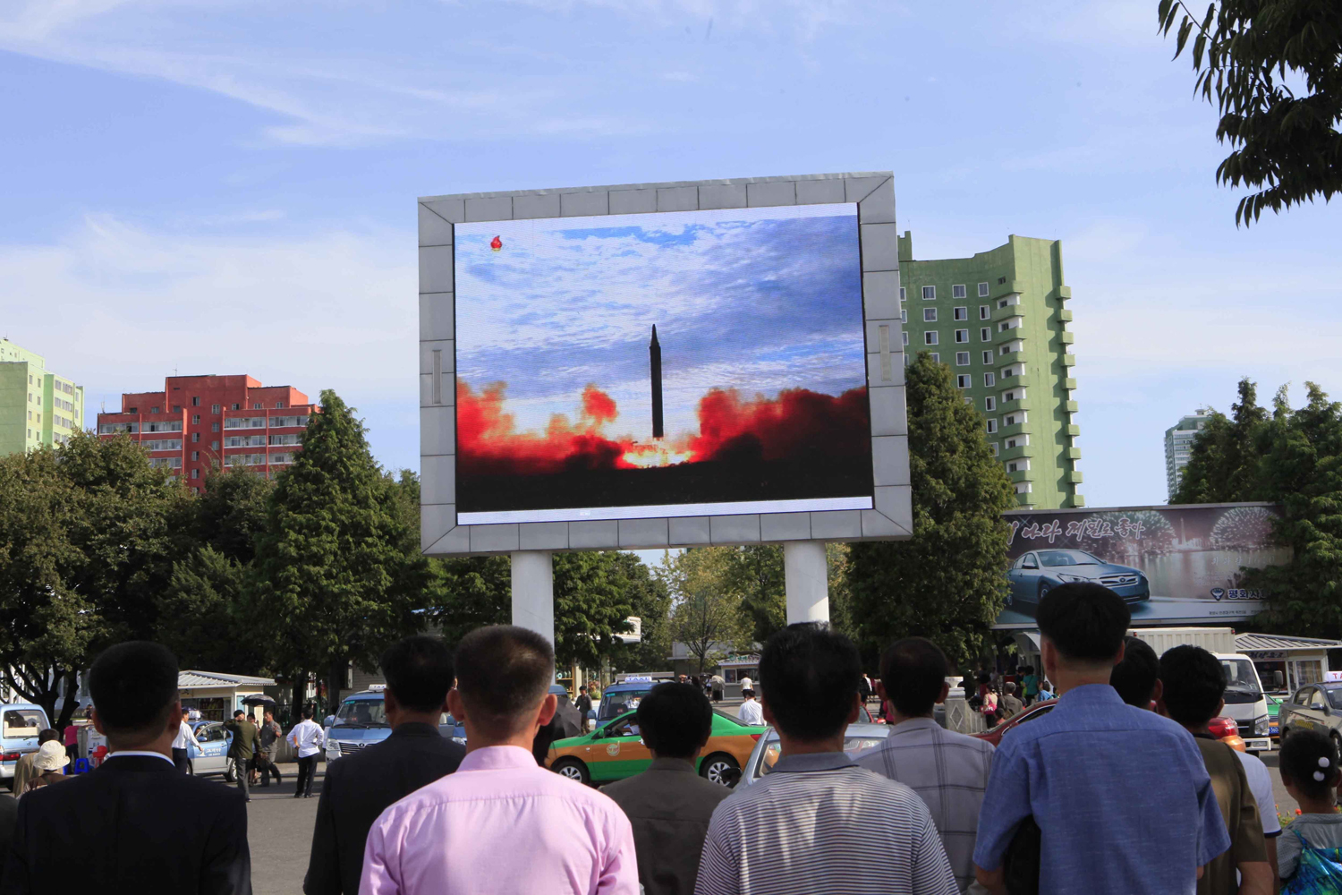People watch a launching of a Hwasong-12 strategic ballistic rocket aired on a public TV screen at the Pyongyang Train Station in Pyongyang, North Korea, Saturday, Sept. 16, 2017. (Jon Chol Jin/AP)