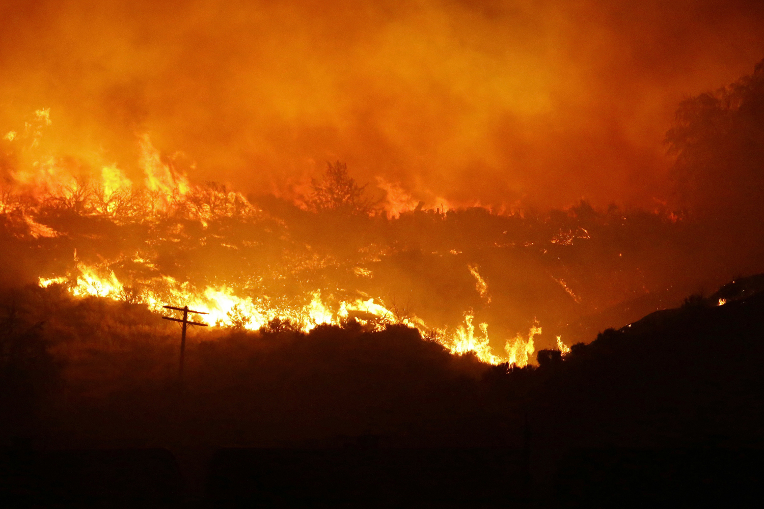 A wildfire burns on a hillside near Othello, Wash.. (Ted S. Warren/AP)
