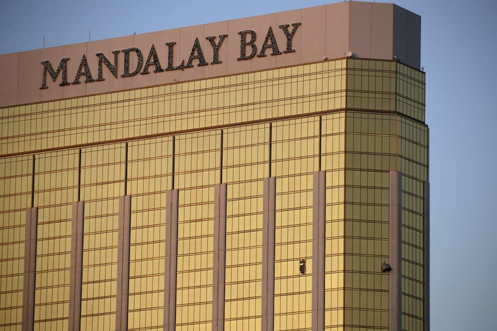 Drapes billow out of broken windows at the Mandalay Bay Resort and Casino on Monday. A gunman was found dead inside a hotel room after shooting at the crowd attending the Route 91 Harvest Festival. (John Locher/AP)