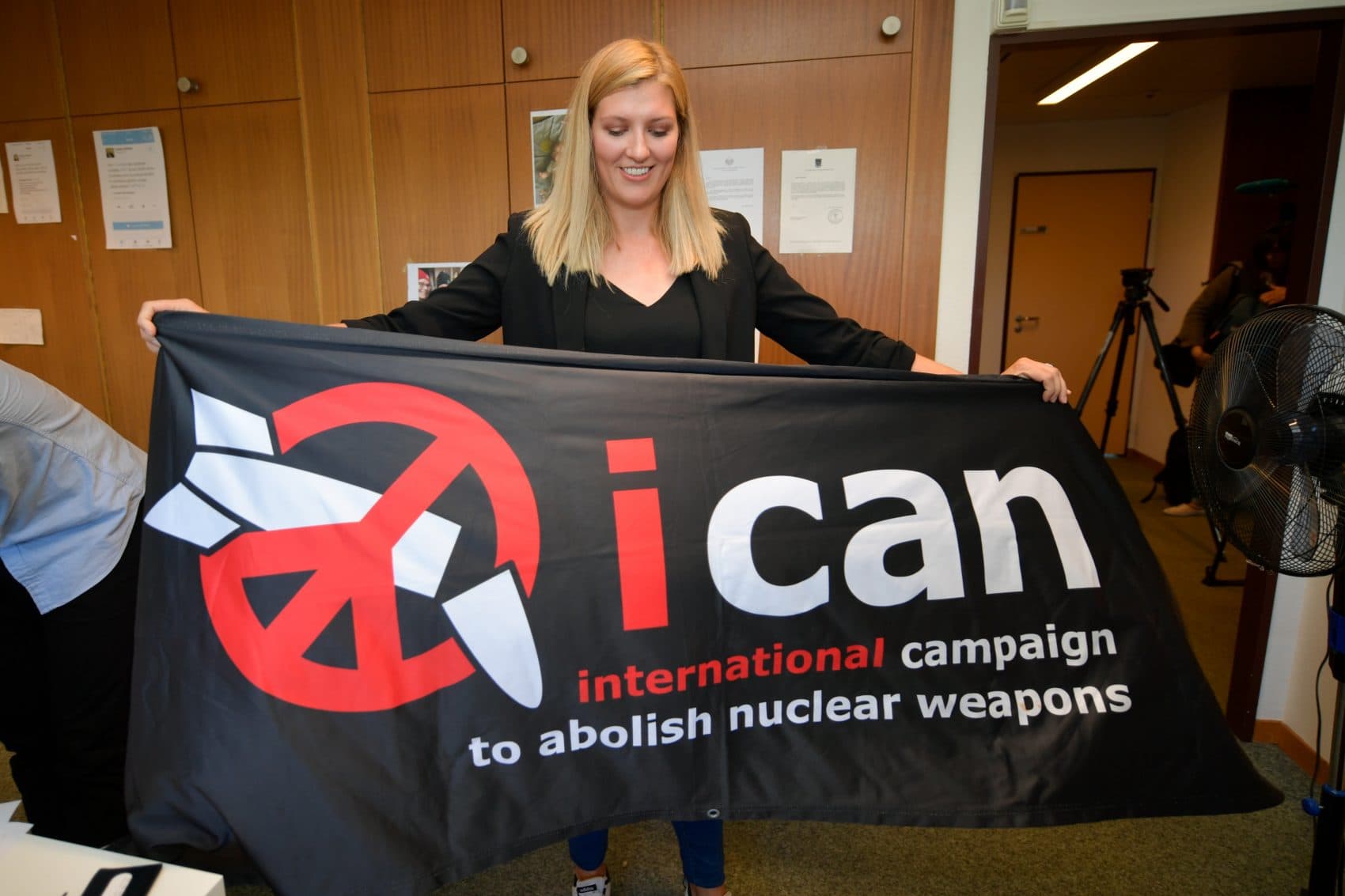 Nuclear disarmament group ICAN executive director Beatrice Fihn holds a banner with their logo after ICAN won the Nobel Peace Prize for its decade-long campaign to rid the world of the atomic bomb as nuclear-fuelled crises swirl over North Korea and Iran, on Oct. 6, 2017, in Geneva. (Fabrice Coffrini/AFP/Getty Images)