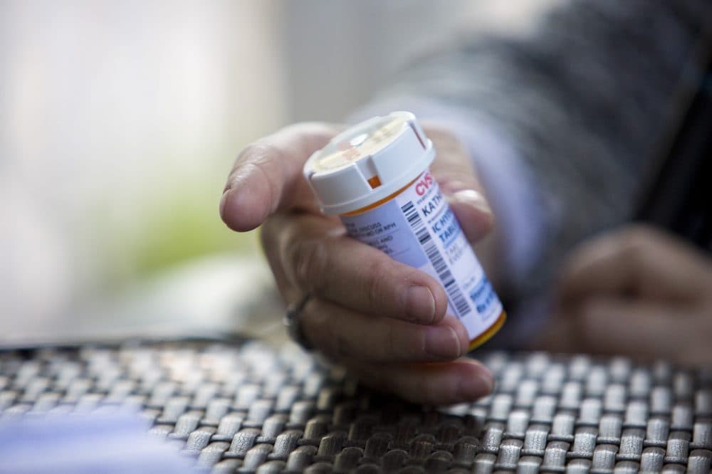 Herzog holds a prescription bottle of the remaining tablets of Dilaudid. (Jesse Costa/WBUR)