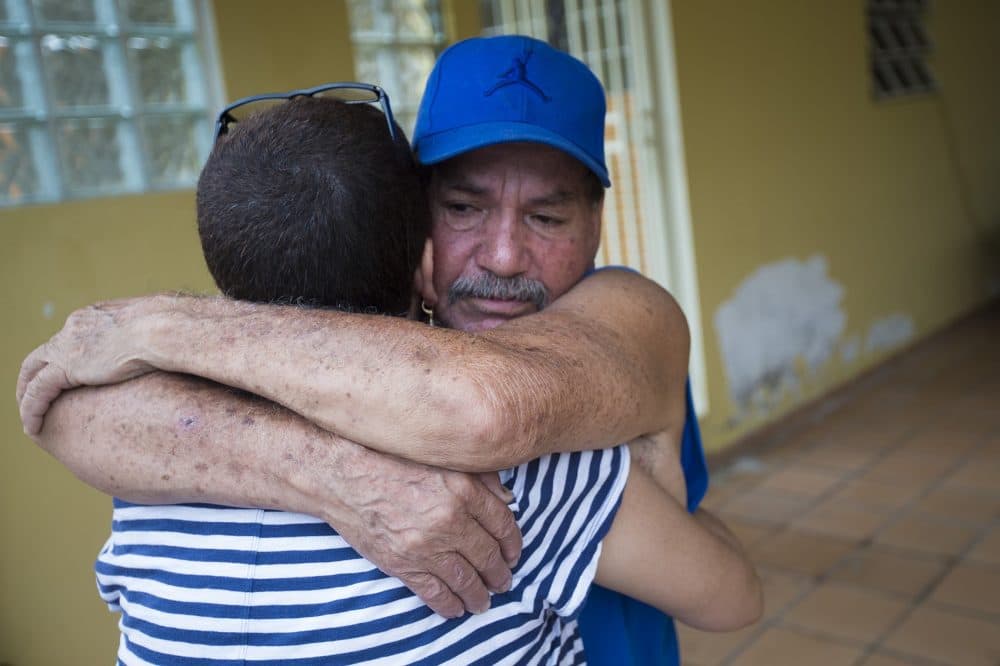 Ivonne Beltran embraces her uncle Huberto Beltrand, who lives in Corozal. (Jesse Costa/WBUR)