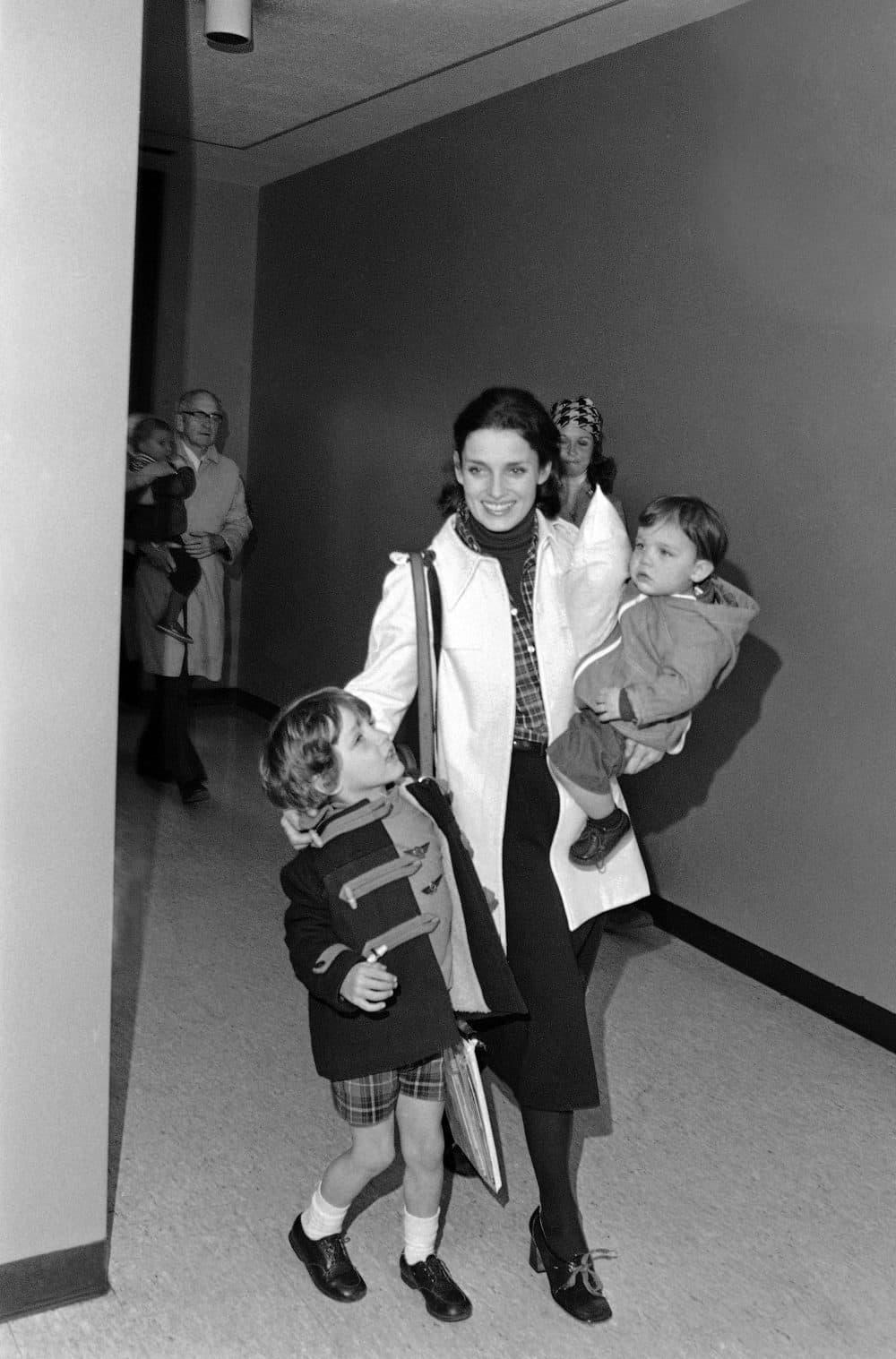 Trudeau arrives at Boston's Logan Airport carrying her son Michel and walking with her other son, Justin, April 11, 1977. (AP Photo)