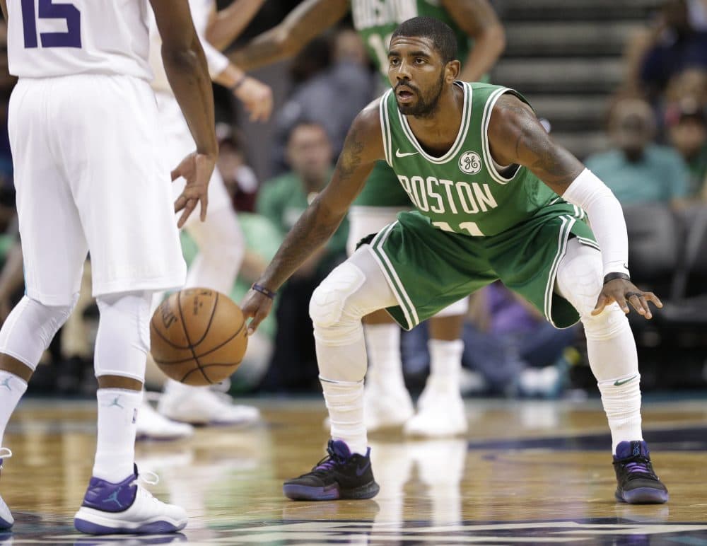 Boston Celtics' Kyrie Irving guards Charlotte Hornets' Kemba Walker in the first half. (Chuck Burton/AP)