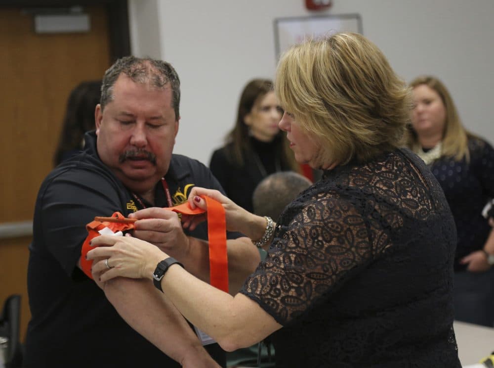 Two staffers from the Three Village Central School District in Stony Brook, N.Y., practice applying a tourniquet to one another during a first aid training session at Stony Brook University, Tuesday, Nov. 29, 2016, in New York. (Michael Balsamo/AP)
