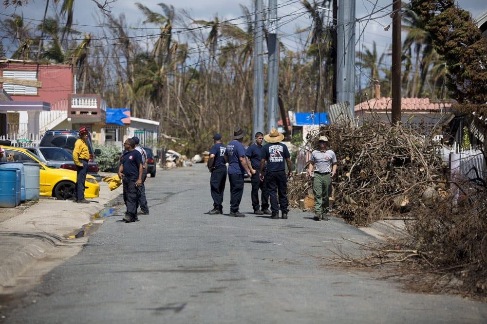 A group consisting of the Chicago Fire Department and Puerto Rico Fire Corps arrive on the scene to assist residents on Cll 19 in Punta Santiago. (Jesse Costa/WBUR)