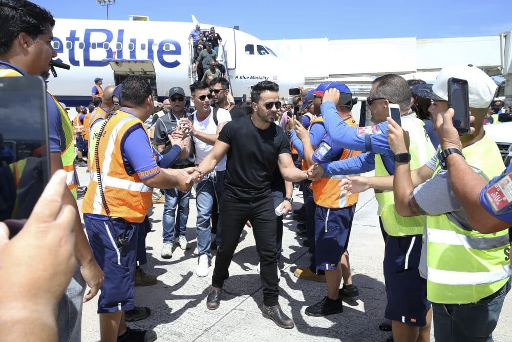 Singers Luis Fonsi, Ricky Martin and other Latin celebrities greet JetBlue crewmembers upon arrival at Luis Muñoz Marín International Airport in San Juan, Puerto Rico. The mission was part of a #100x35JetBlue special relief effort with JetBlue aimed at raising awareness and delivering aid to the people of Puerto Rico. (JetBlue via AP Images)