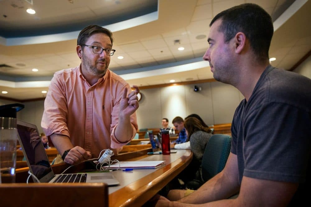 Suffolk Law School professor Gabe Teninbaum, left, talks with a student during class. Teninbaum teaches a course called &quot;Lawyering in the Age of Smart Machines.&quot; (Jesse Costa/WBUR)