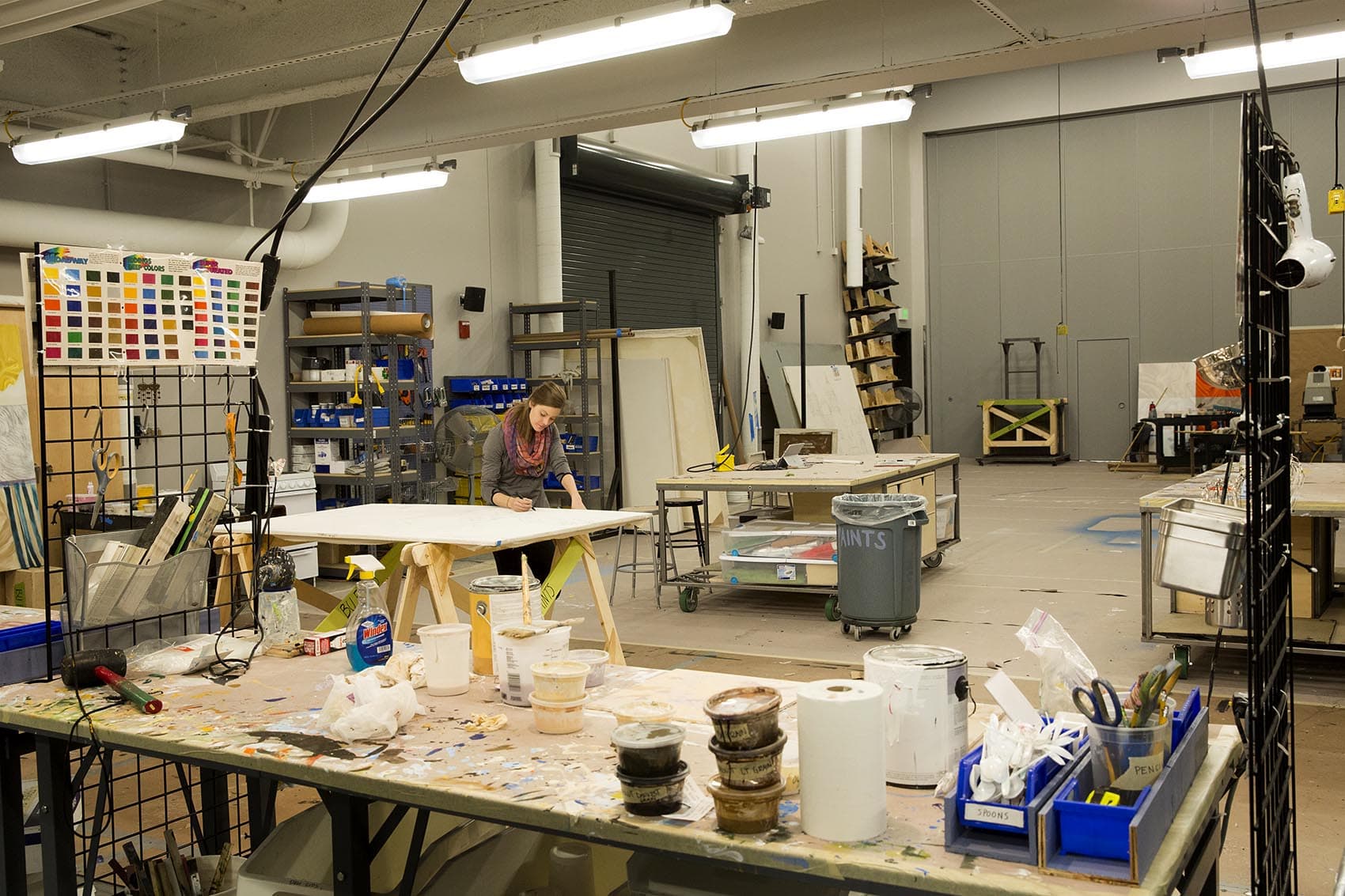 Katie Keaton, a second-year scenic painting graduate student, works in BU's new theater production center. (Robin Lubbock/WBUR)