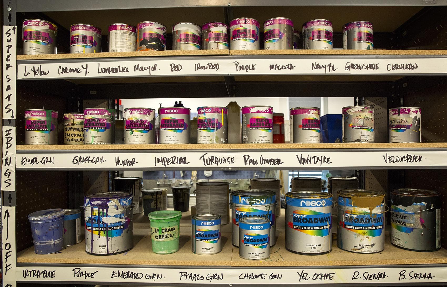 Shelves of paint at the BU theater production center. (Robin Lubbock/WBUR)