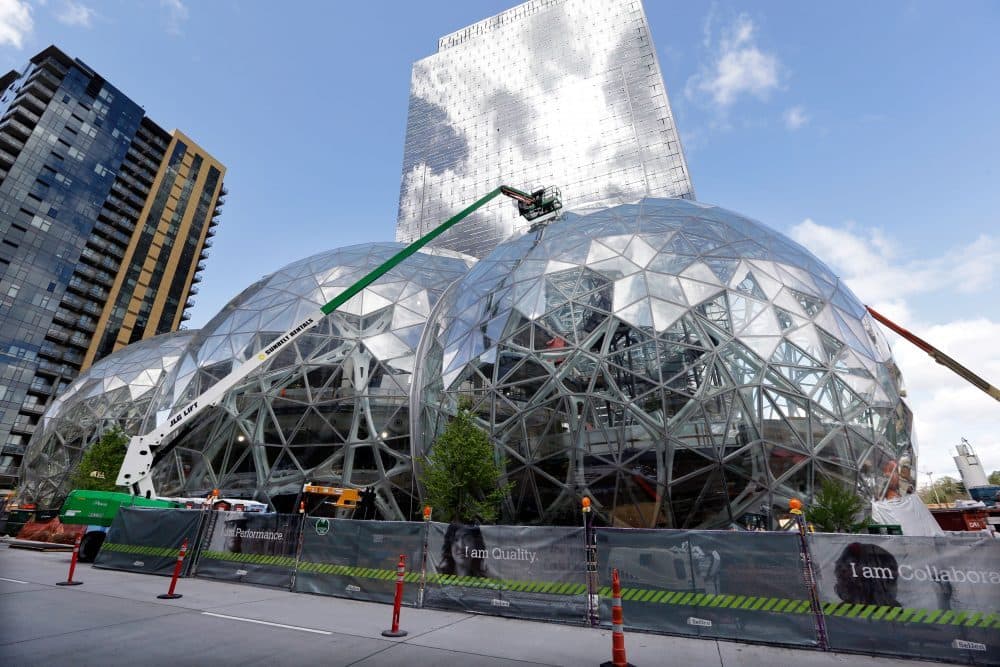 In this April 27 file photo, construction continues on three large domes as part of an expansion of the Amazon campus in downtown Seattle. Amazon has said it will spend more than $5 billion to build another headquarters in North America to house as many as 50,000 employees. (Elaine Thompson/AP)