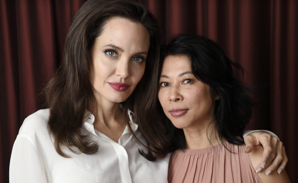 Angelina Jolie, left, director/co-writer of the film "First They Killed My Father: A Daughter of Cambodia Remembers," and co-writer/human rights activist Loung Ung pose for a portrait during the Toronto International Film Festival in Toronto. (Chris Pizzello/Invision/AP)