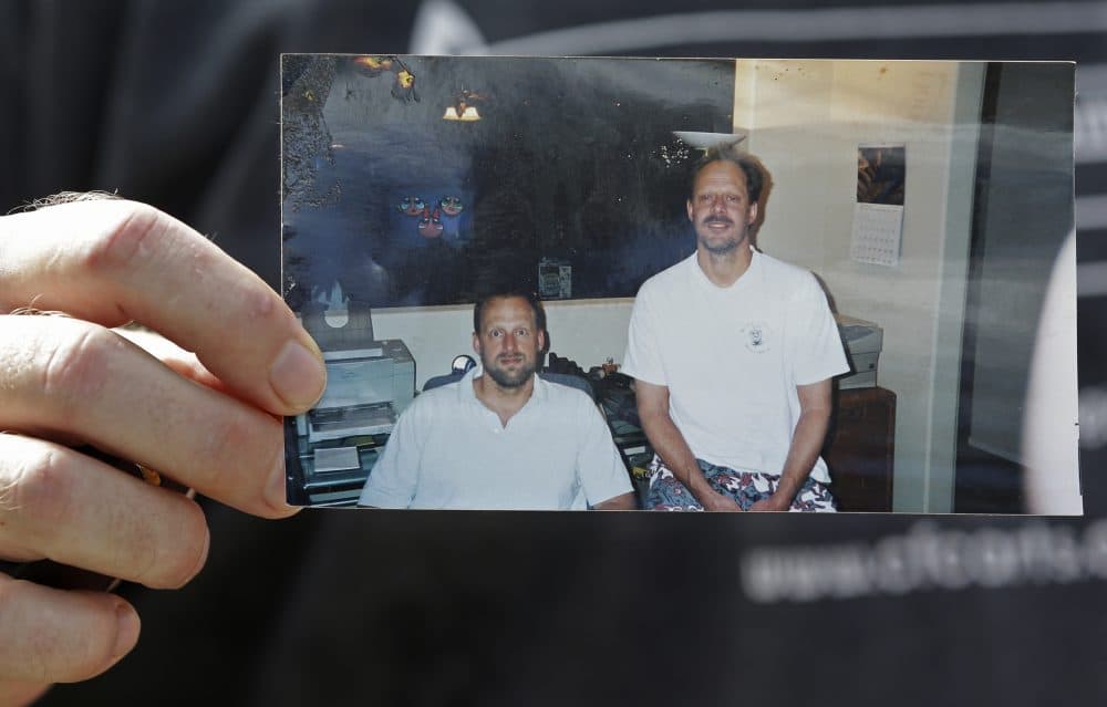 Eric Paddock holds a photo of him, at left, and his brother, Stephen Paddock, at right, outside his home, Monday, Oct. 2, 2017, in Orlando, Fla. (John Raoux/AP)
