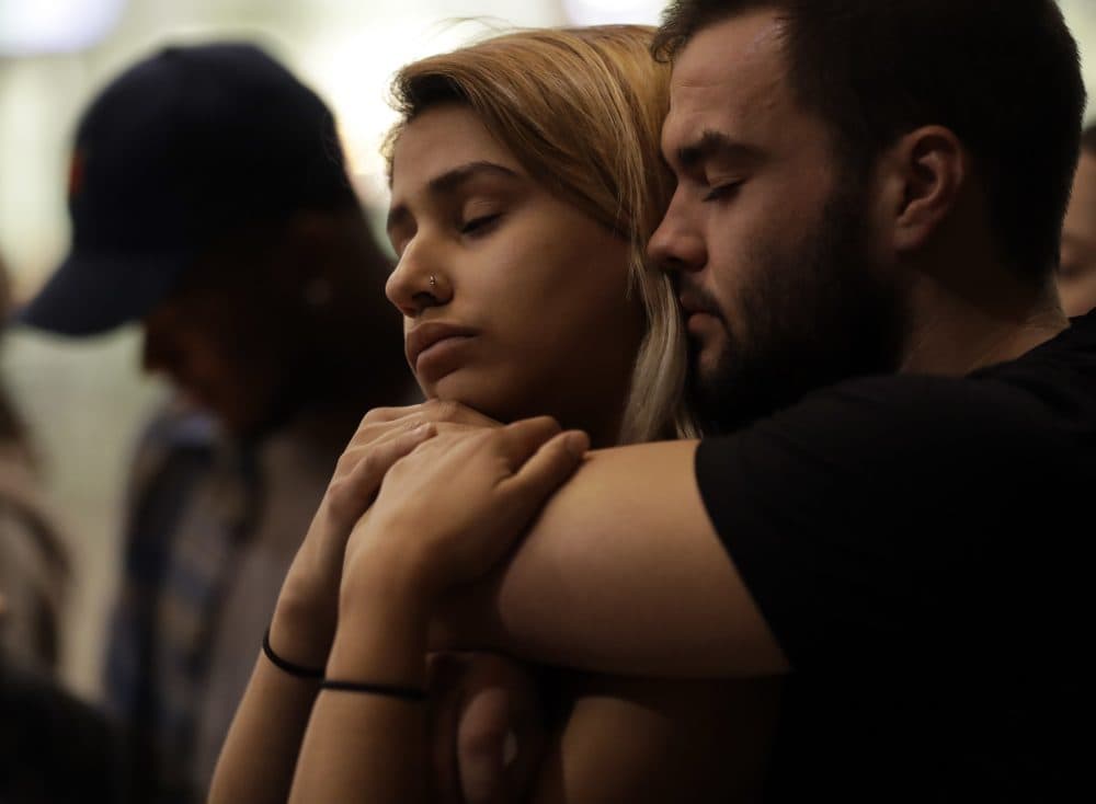 University of Nevada Las Vegas students Raymond Lloyd, right, and Karla Rodriguez take part in a vigil Monday, Oct. 2, 2017, in Las Vegas. (Gregory Bull/AP)