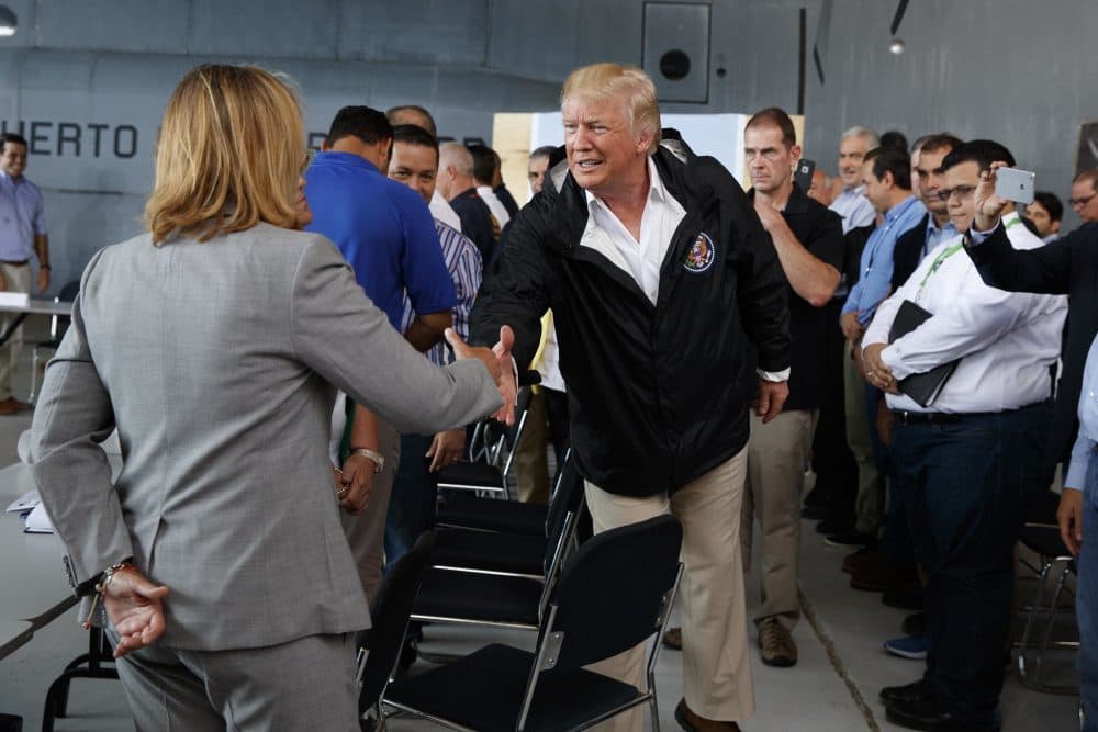 President Donald Trump shakes hands with San Juan Mayor Carmen Yulin Cruz during a briefing on hurricane recovery efforts in San Juan, Puerto Rico. (AP Photo/Evan Vucci)