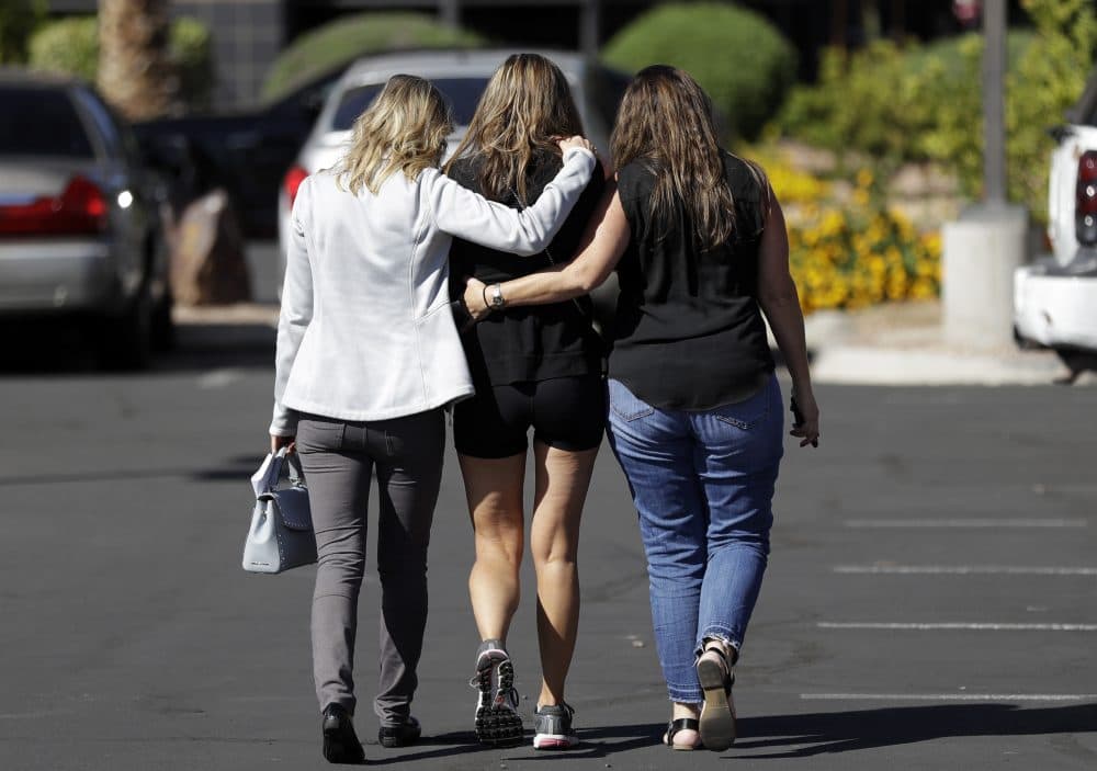 Kris Delarosby, right, and Colleen Anderson, left, hold Charleen Jochim, center, as they walk towards a hospital in search of information on a missing friend, Steven Berger of Minnesota, Tuesday, Oct. 3, 2017, in Las Vegas. The parents of Berger, who had been missing after the mass shooting in Las Vegas, say they have been notified on Tuesday afternoon that he was killed in the attack. (Gregory Bull/AP)