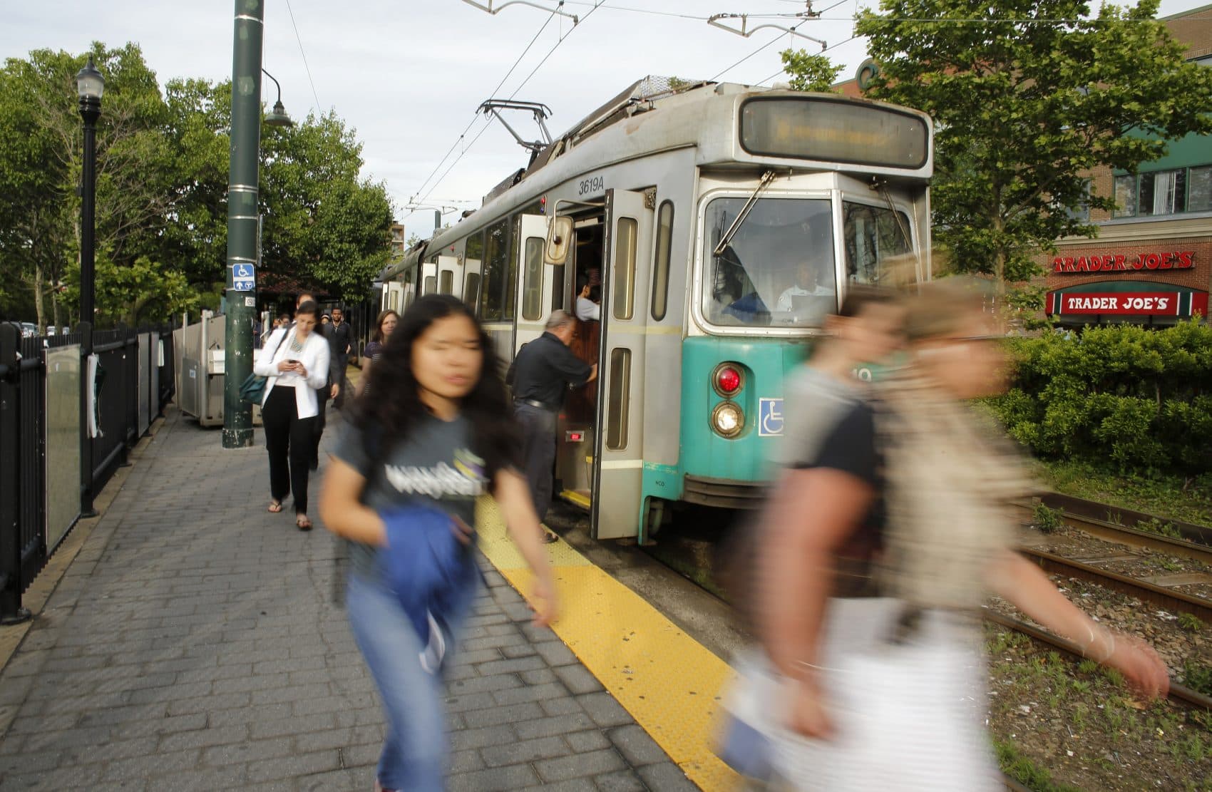 In this Wednesday, June 17, 2015 photo, commuters disembark from a Massachusetts Bay Transportation Authority train in Brookline, Mass. The subway system in the Boston metro area is the nation's oldest, launched in 1897. Public transportation has long been hailed as a certain remedy for traffic congestion, but many of the nation's largest mass transit systems are struggling to keep up with maintenance and expansion. (Steven Senne/AP)