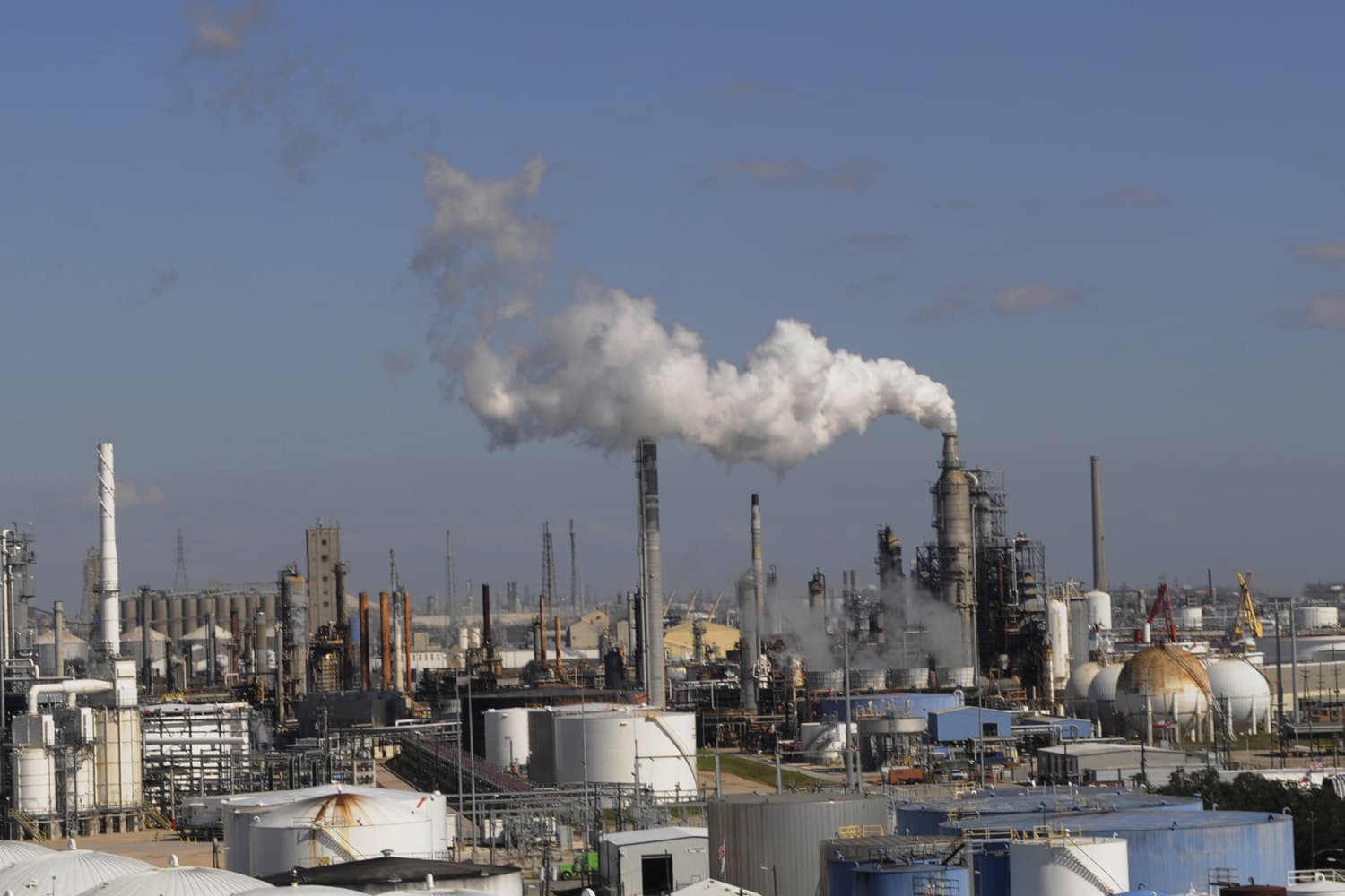 In this Feb. 25, 2010 file photo, refineries and chemical plants release steam near the Houston ship channel. (Pat Sullivan/AP)