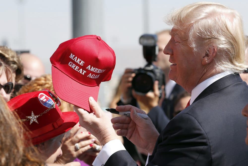 President Donald Trump hands a signed "Make America Great Again," hat back to a supporter, Wednesday, Aug. 23, 2017, in Reno, Nev. (Alex Brandon/AP)