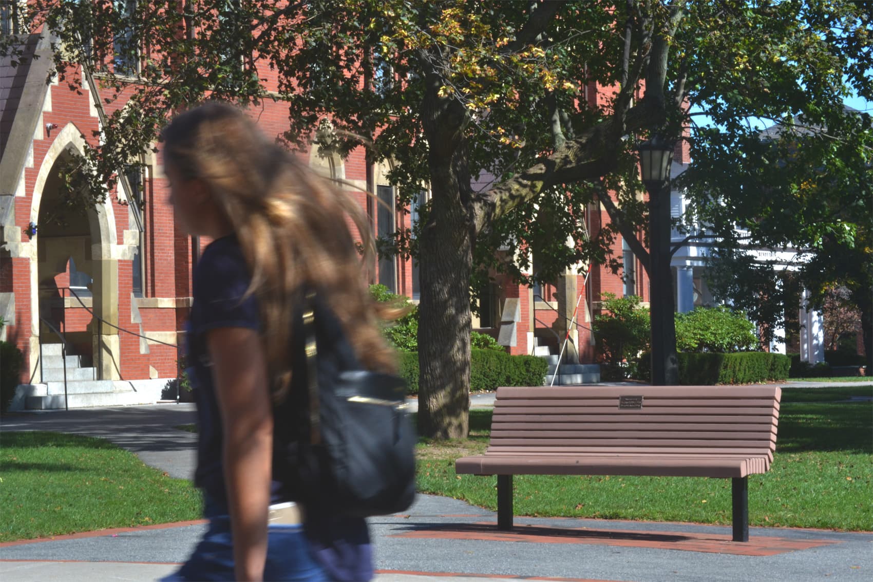 This bench, donated in honor of a member of the class of 1991 who died in a car accident before graduating, is part of the Tufts African American Freedom Trail. (Alexa Vazquez/WBUR)