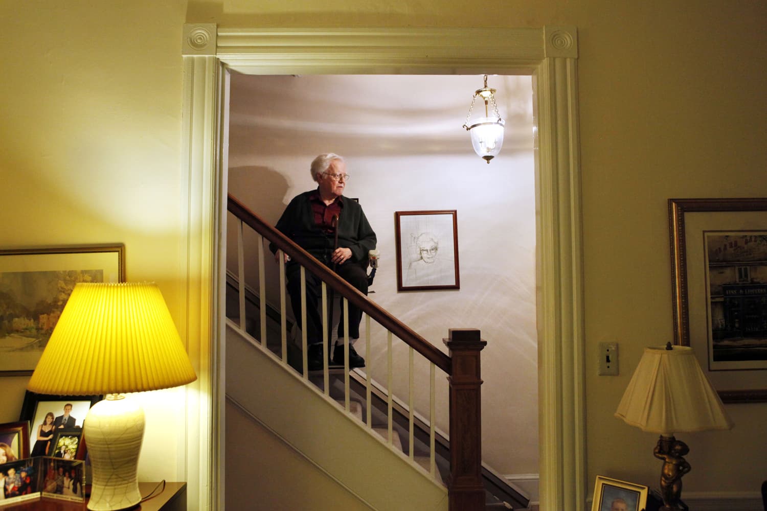In this photo taken Oct. 12, 2011, Irving Lindenblad, 82, rides down the stairs assisted by a stair lift, at his home in Washington. (Jacquelyn Martin/AP)