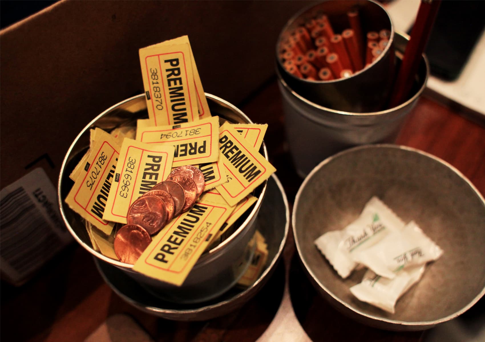 Tickets and pennies reward the winners, sometimes chosen arbitrarily, of games that lead participants through the game of "Waiting Rooms" at the Museum of Science. (Courtesy Ida C. Benedetto/Museum of Science)
