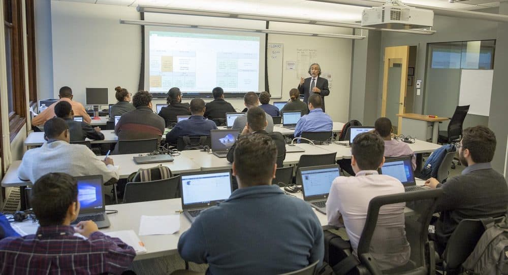 Kayvan Sabery, an instructor of information technology, talks to his class at Year Up. (Robin Lubbock/WBUR)