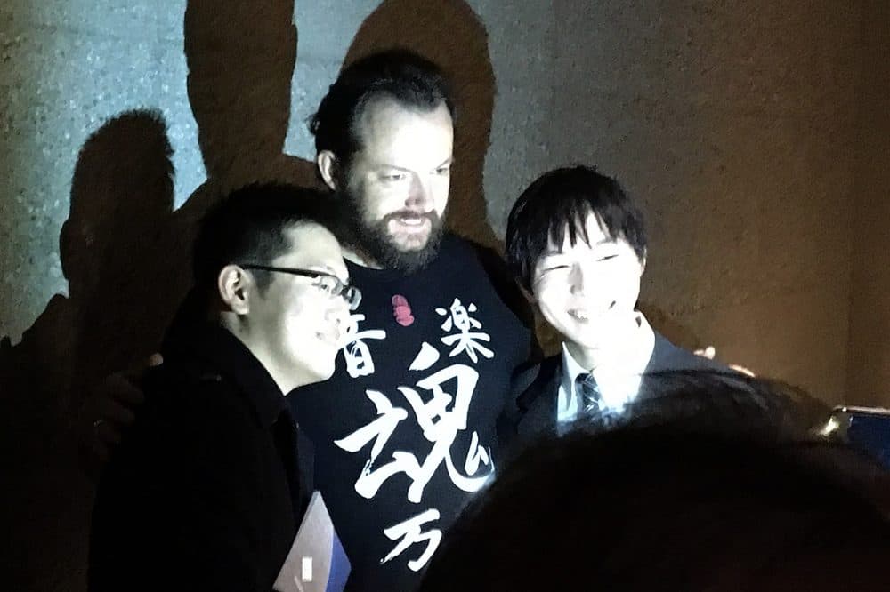 Andris Nelsons stopped for a selfie with superfans Takuya Hiroaka, left, and Yuki Satake. (Andrea Shea/WBUR)