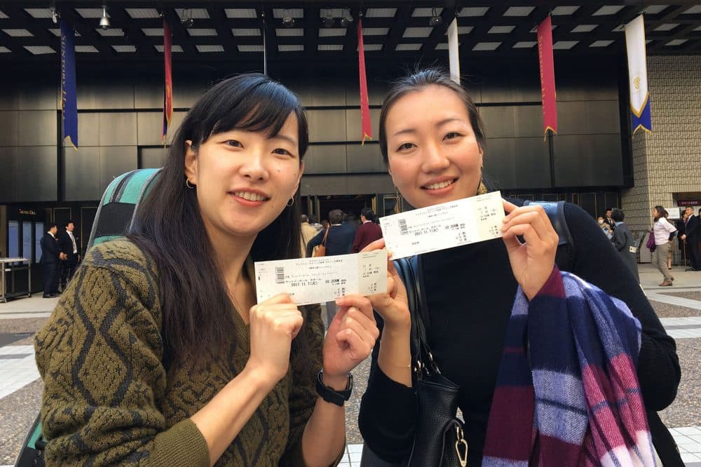 Two attendees of Tuesday's open rehearsal at Suntory Hall in Tokyo. (Andrea Shea/WBUR)