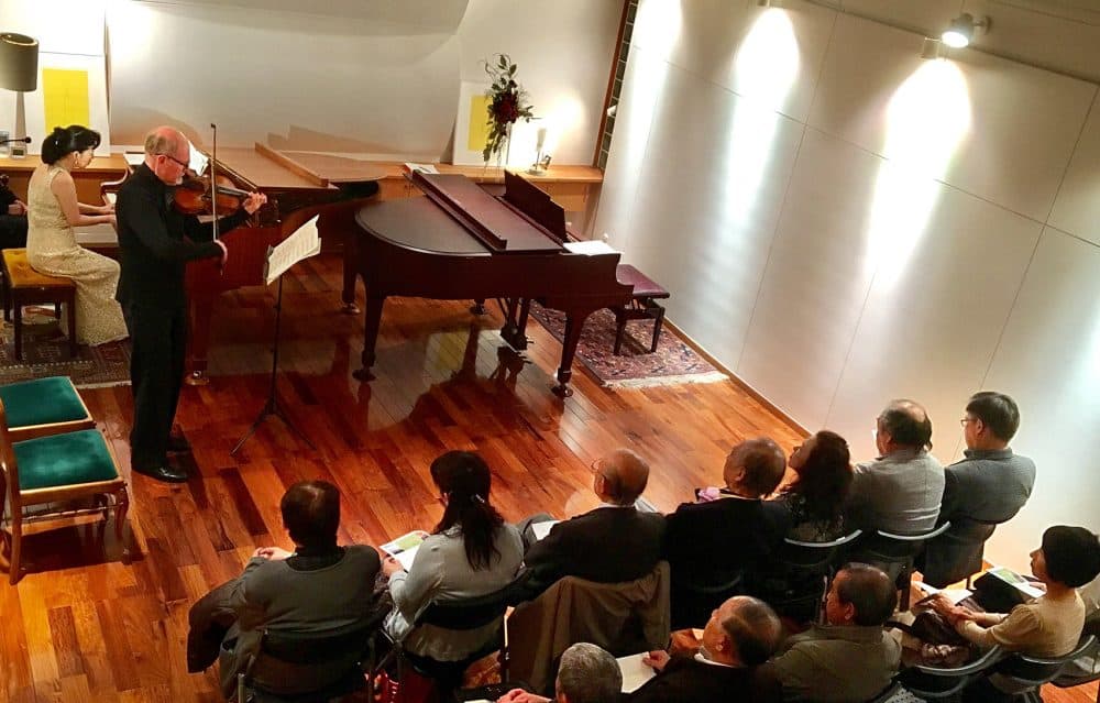 Boston Symphony Orchestra violinist Michael Zaretsky and Japanese pianist Chikako Shibata perform at a private musical hall on Monday in Ishinomaki, Japan. (Andrea Shea/WBUR)