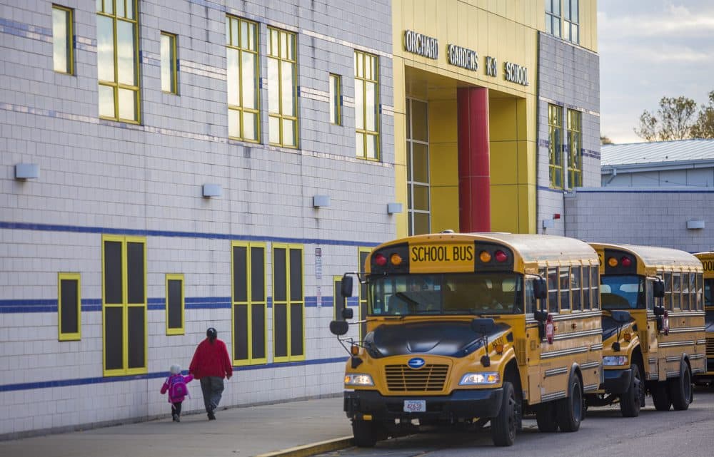 Buses idle as drivers wait for students to board outside the Orchard Gardens K-8 Pilot School. (Jesse Costa/WBUR)