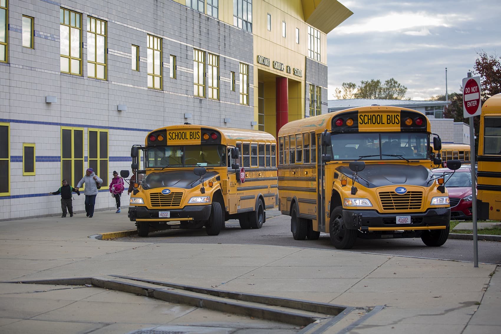 Buses idle as drivers wait for students to board outside the Orchard Gardens K-8 Pilot School. (Jesse Costa/WBUR)