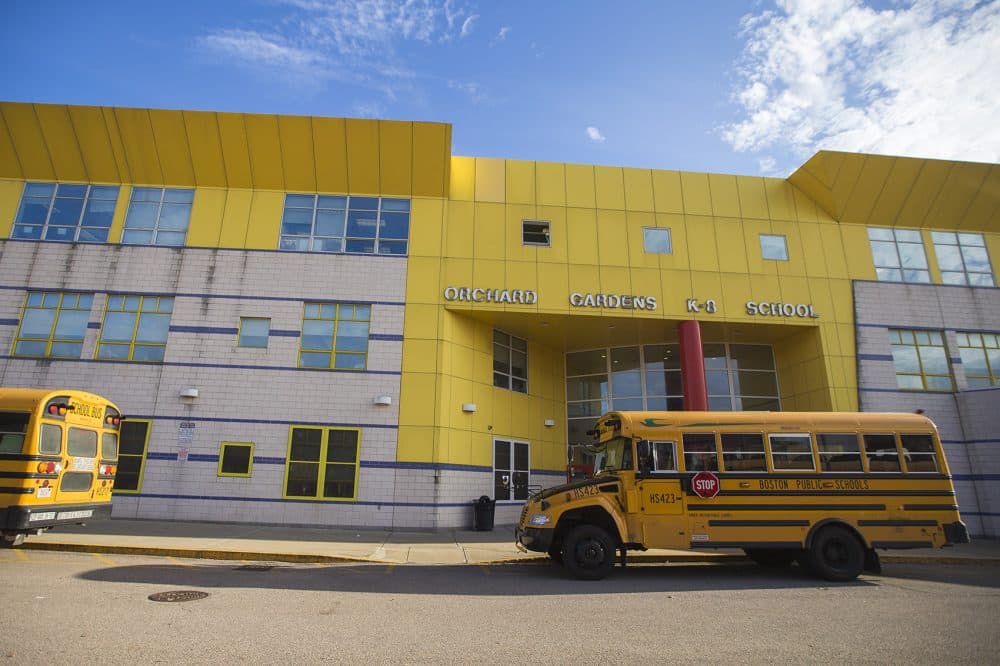 Buses idle as drivers wait for students to board outside the Orchard Gardens K-8 Pilot School. (Jesse Costa/WBUR)