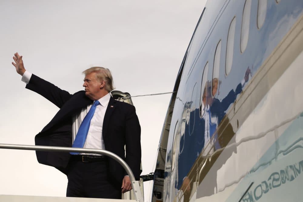 President Trump waves goodbye as he enters Air Force One after participating in the East Asia Summit on Nov. 14 in Manila, Philippines. (Andrew Harnik/AP)