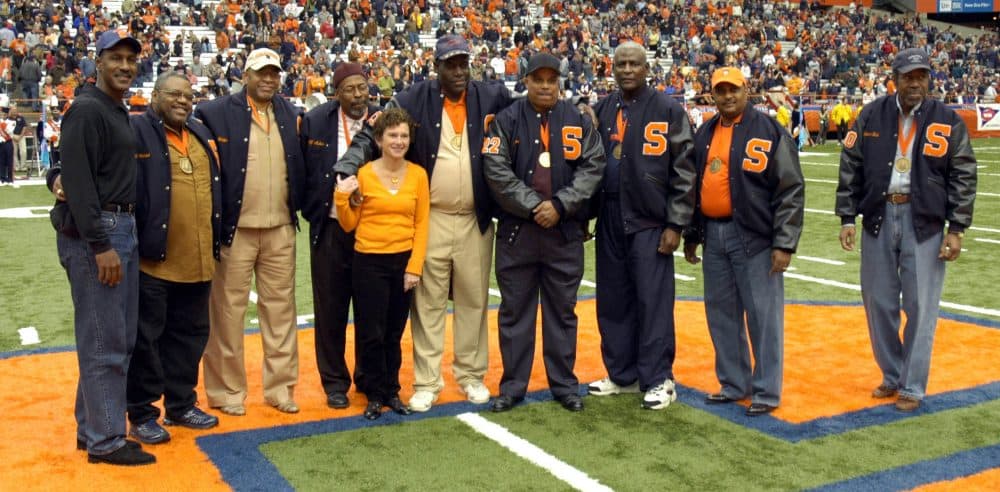 In 2006, the university recognized the 'Syracuse 8' for their stand against discrimination. Left to right: Art Monk, Ron Womack, Duane Walker, Alif Muhammad, Syracuse Chancellor Nancy Cantor, Clarence McGill, Dana Harrell, John Lobon, Greg Allen and Richard Bulls. (Kevin Rivoli/AP)