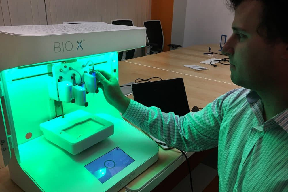 Biomaterial engineer Patrick Thayer of CELLINK demonstrates the BIO X 3D printer. (Bruce Gellerman/WBUR)