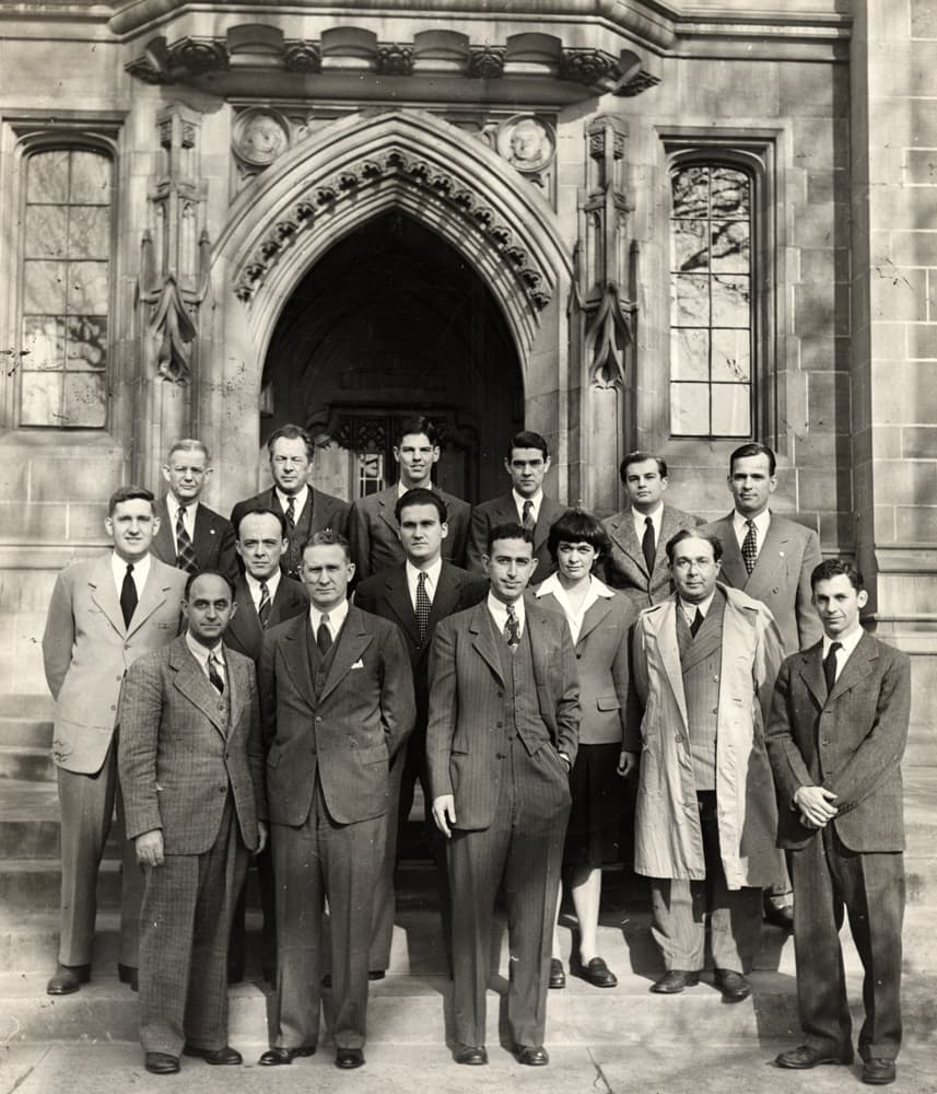 A reunion of atomic scientists in 1946 on the fourth anniversary of the first controlled nuclear fission chain reaction. Pictured in front of Bernard A. Eckhart Hall at the University of Chicago, from left (3rd row): Norman Hilberry; Samuel Allison; Thomas Brill; Robert G. Nobles; Warren Nyer; Marvin Wilkening; (2nd row): Harold Agnew; William Sturm; Harold Lichtenberger; Leona W. Marshall; Leo Szilard; (1st row): Enrico Fermi; Walter H. Zinn; Albert Wattenberg; Herbert L. Anderson. (Courtesy Life Magazine)