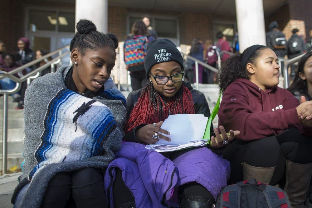 From left to right, seniors Juliette Estime, Baylee Mendez Rainey and Penelope Cruz participated in Thursday morning's walkout at Brookline High in response to the racially offensive videos made by some current and former students on Snapchat. (Jesse Costa/WBUR)