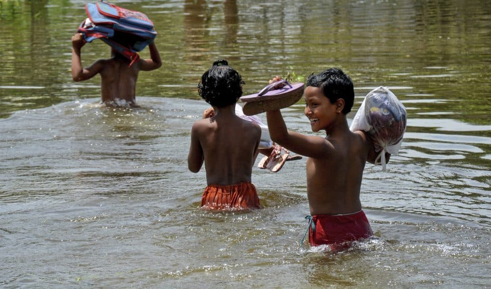 In this Saturday, Aug. 19, 2017, file photo, schoolchildren wade past floodwaters in Gaibandha district, about 120 miles (192 kilometers) north of capital Dhaka, Bangladesh. This week’s flooding in Houston is unprecedented, but such devastation is chronic across South Asia. Experts say local officials are ignoring dangers and pursuing development plans that only increase the risk of flood-related death and destruction as annual monsoon rains challenge cities to cope. (AP)