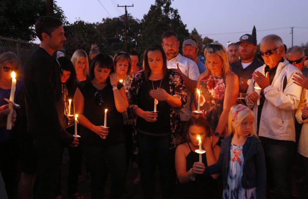 Friends and relatives stand at a candlelight vigil for Nicol Kimura, a victim of the Las Vegas mass shooting, at Sierra Vista Elementary School in Placentia, Calif., Sunday, Oct. 8, 2017. (Reed Saxon/AP)