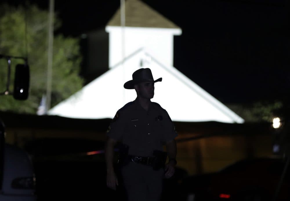 A law enforcement official walks past the First Baptist Church of Sutherland Springs, the scene of a mass shooting, Sunday, Nov. 5, 2017, in Sutherland Springs, Texas. (Eric Gay/AP)
