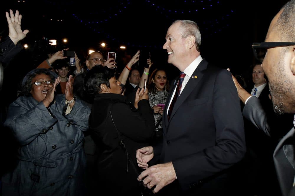 New Jersey gubernatorial nominee Phil Murphy, center, is greeted by supporters as he arrives to his election night victory party at the Asbury Park Convention Hall, Tuesday, Nov. 7, 2017, in Asbury Park, N.J. (Julio Cortez/AP)
