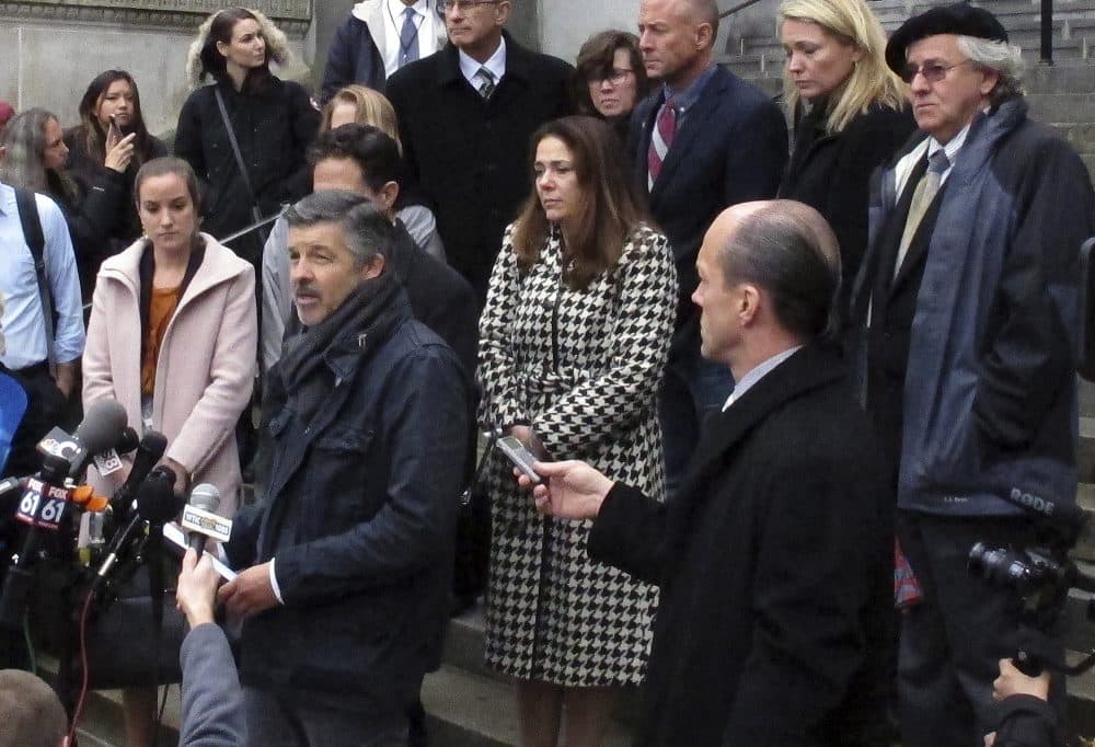 Ian Hockley, front left, father of Dylan Hockley, one of the children killed in the 2012 Sandy Hook Elementary School shooting, speaks outside the Connecticut Supreme Court Tuesday in Hartford, following an appeal hearing on whether gunmaker Remington Arms should be held liable for the massacre. (Dave Collins/AP)