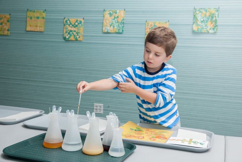 A museum visitor experiments with various liquids, including Boston Harbor Water (Courtesy Galya Feierman ICA)