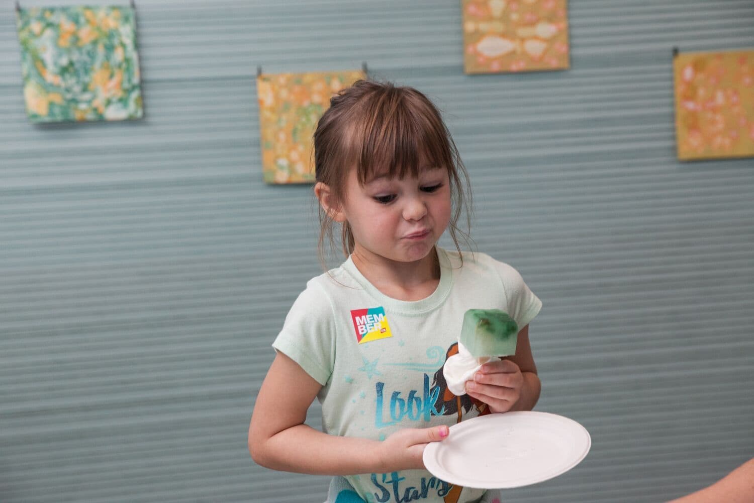 Museum visitor tastes artist Evelyn Rydz's phytoplankton popsicle at the ICA. (Courtesy Galya Feierman/ICA)