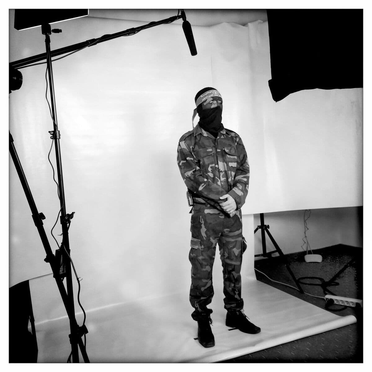 A camouflaged combatant speaks to the camera for a recording that will become part of Karim Ben Khelifa's virtual-reality installation "The Enemy." (Courtesy MIT Museum)